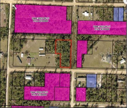 This aerial map shows several land parcels, with one highlighted in red and others in purple — GARDENIA STREET, FOUNTAIN, FL