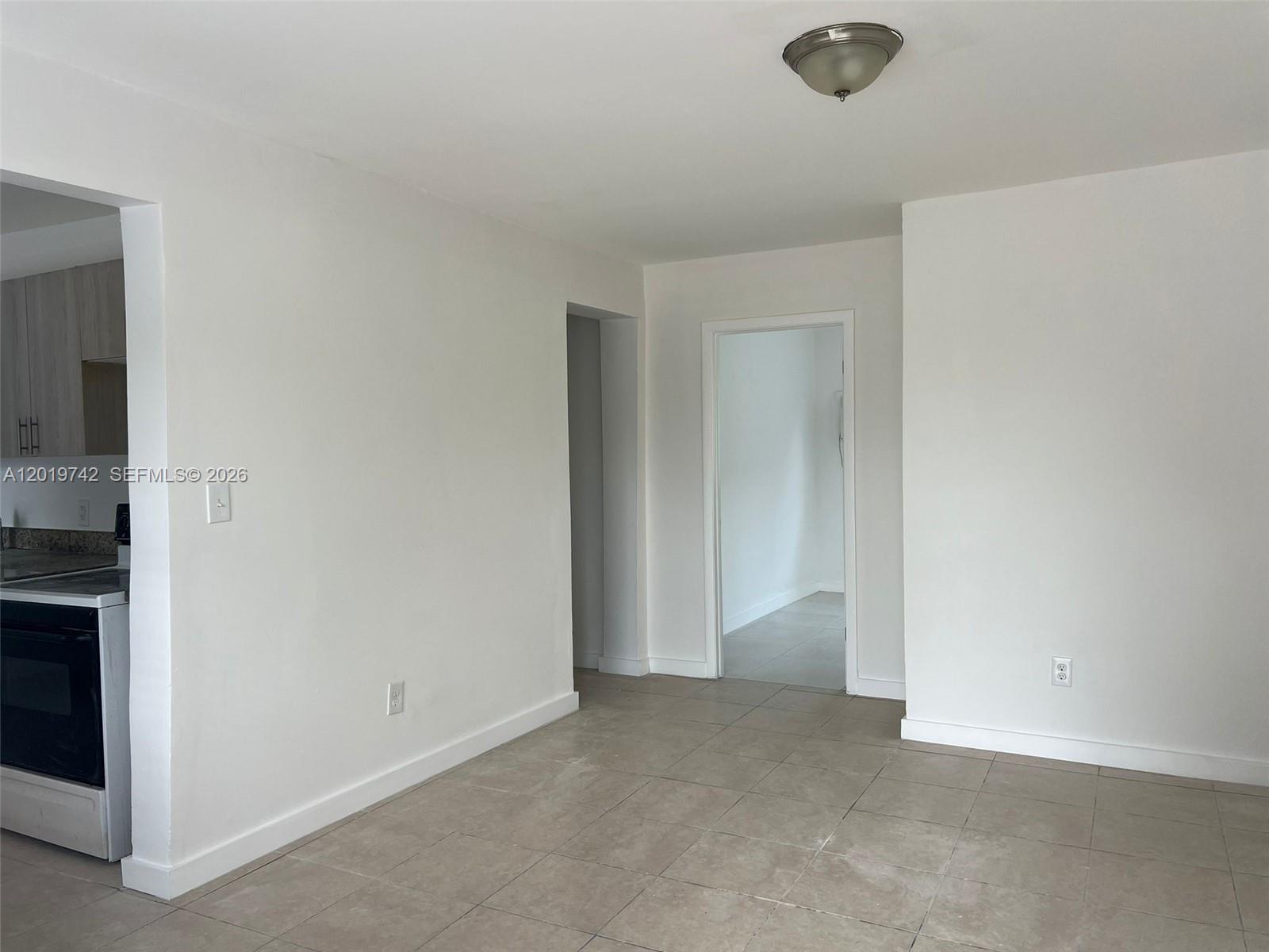 A room with white walls, tile flooring, and two doorways leading to other areas — 4245 NW 24th Ave # 1, Miami FL 33142, MIAMI, FL