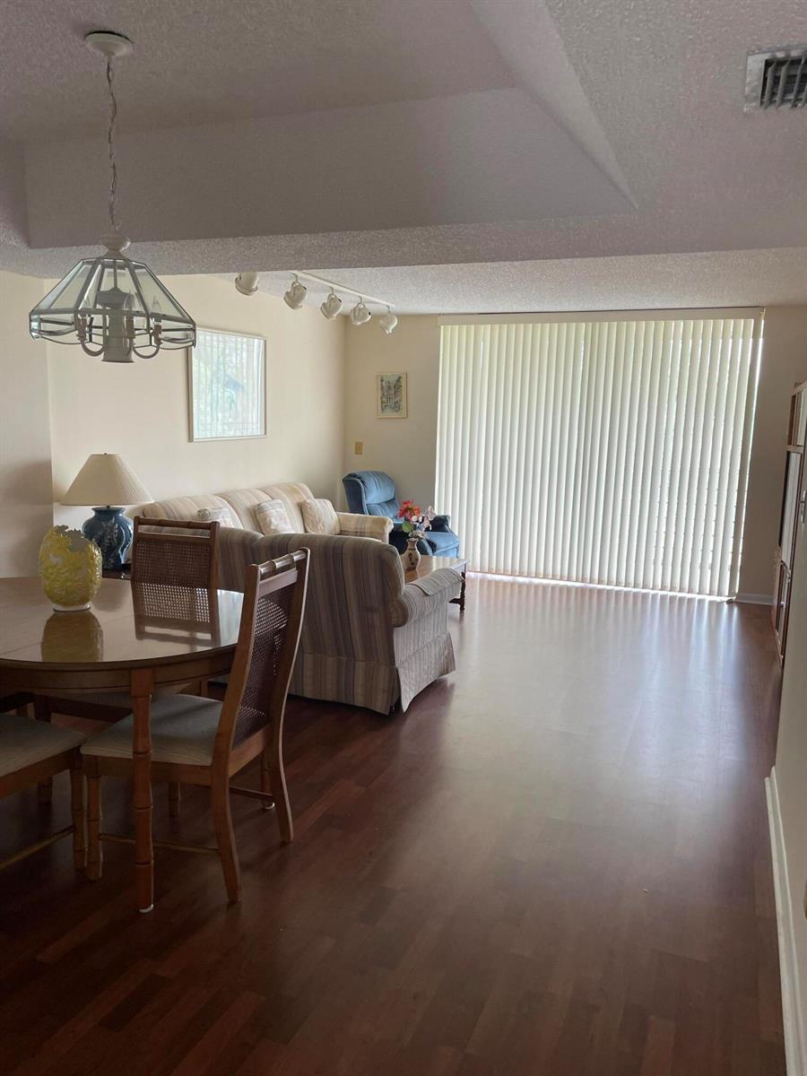 A bathroom features a white vanity with a quartz countertop, a large mirror, and lighting — 3286 Arcara Way # 313, Lake Worth FL 33467, LAKE WORTH, FL