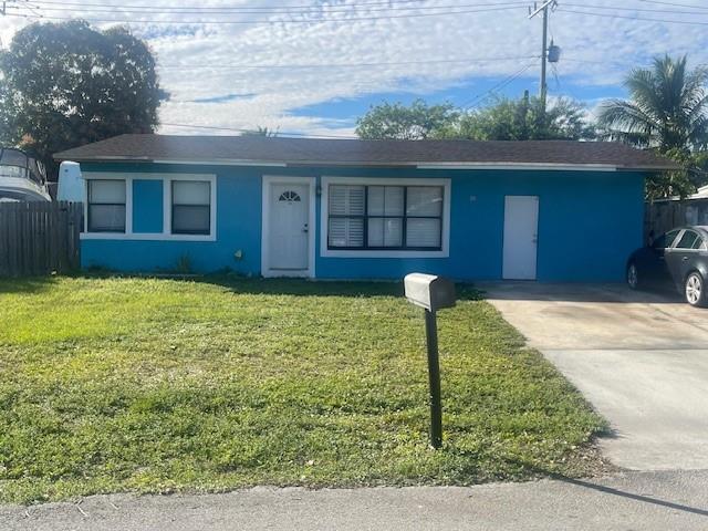 A bright blue single-story house features a front door, large windows, and a concrete driveway — 2531 NE 9th Avenue, Pompano Beach FL 33064, POMPANO BEACH, FL