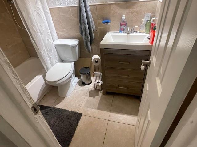 A bathroom features a white toilet, a wood vanity with a sink, and a shower curtain — 2531 NE 9th Avenue, Pompano Beach FL 33064, POMPANO BEACH, FL