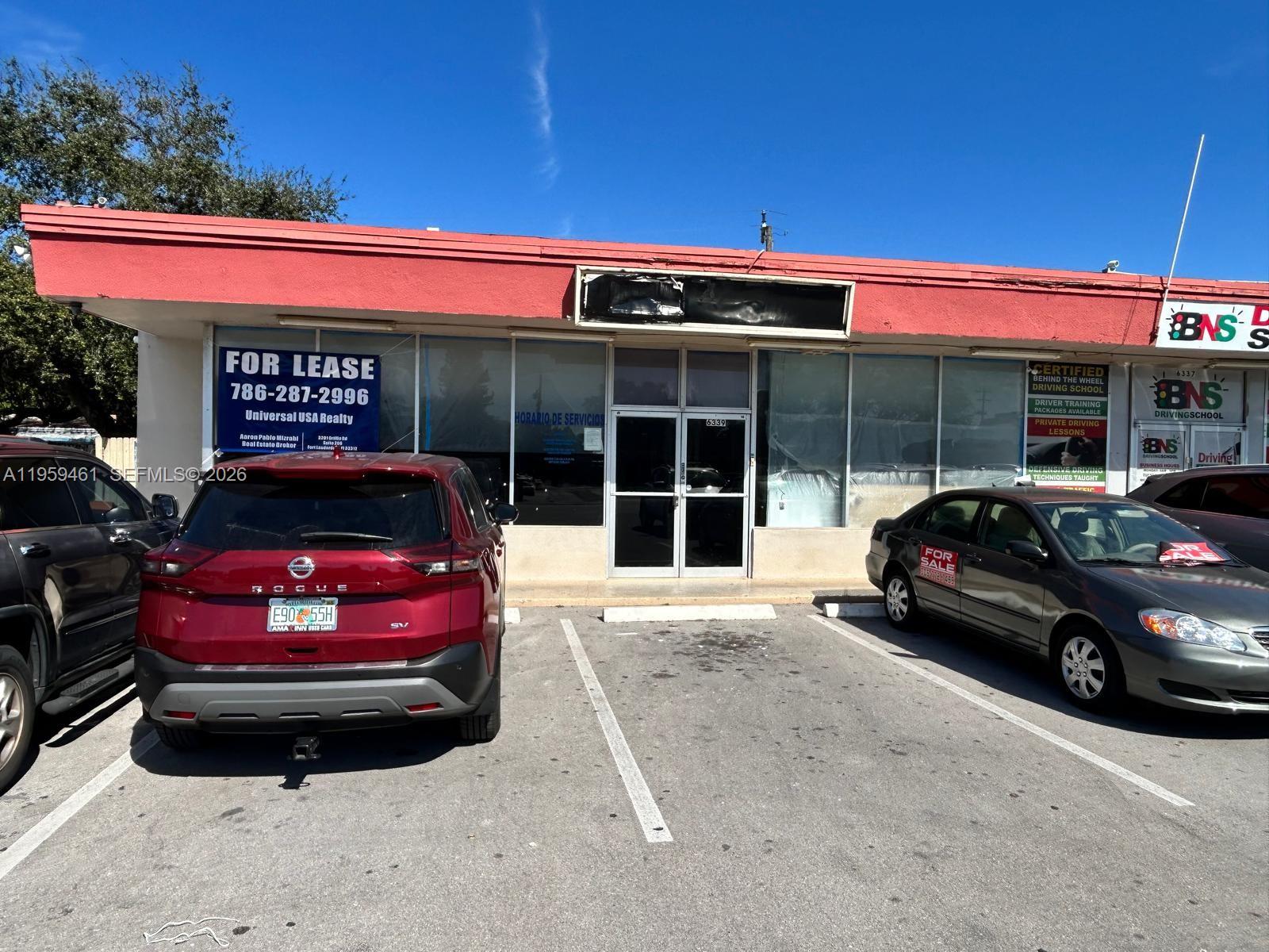 A commercial storefront with a red facade, large windows, and a parking lot in front — 6339 Johnson St, Hollywood FL 33024, HOLLYWOOD, FL