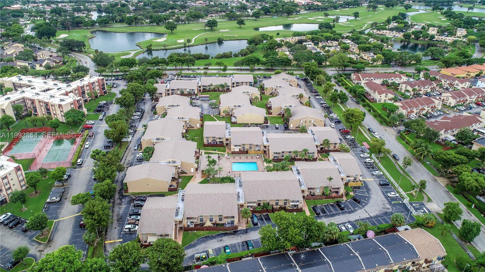 An aerial view shows a multi-building residential complex with a central swimming pool and parking — 13785 SW 66th St # 239C, Miami FL 33183, MIAMI, FL