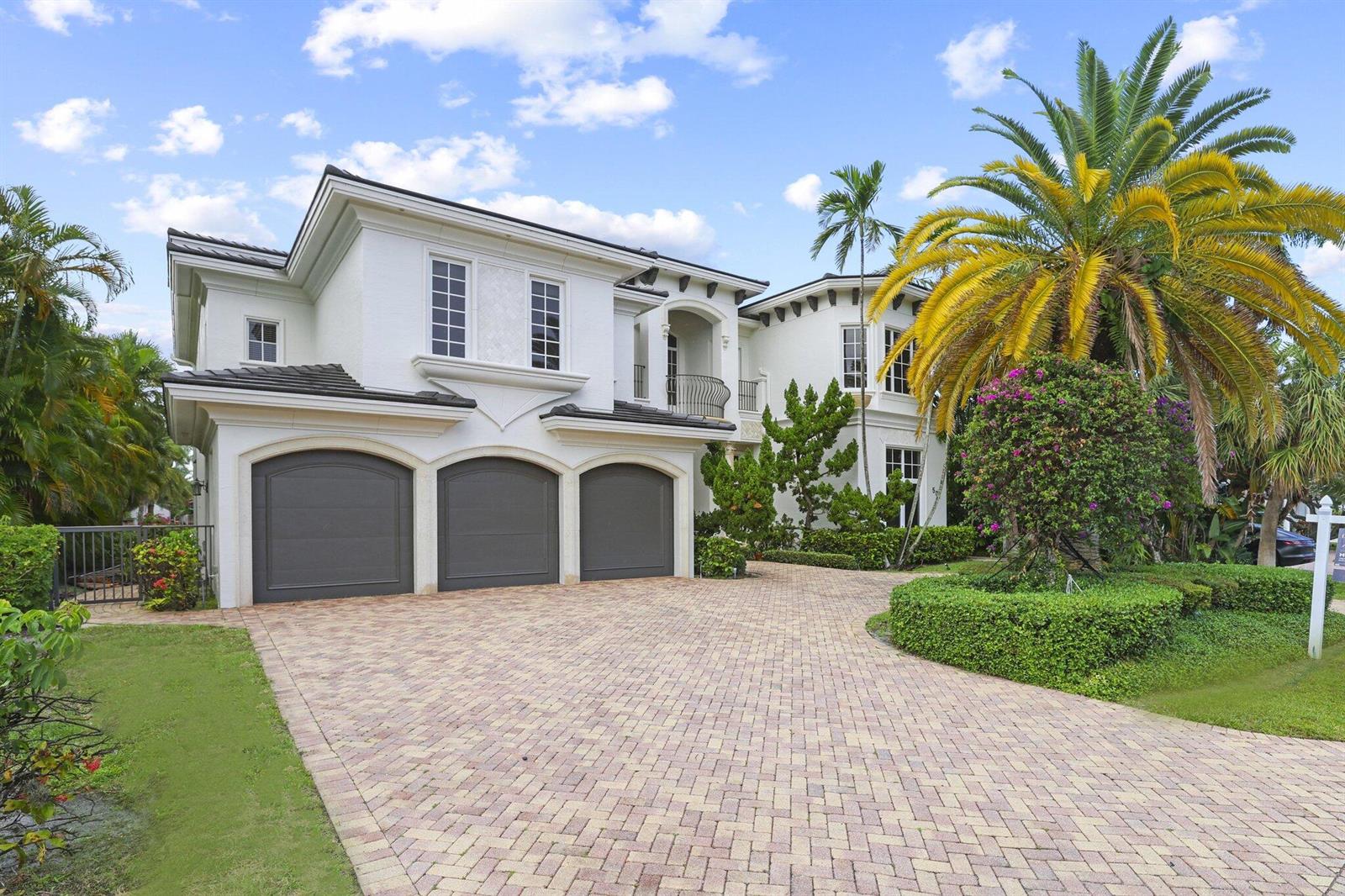 A two-story white house with a three-car garage and a paved driveway — 501 Golden Harbour Drive, Boca Raton FL 33432, BOCA RATON, FL