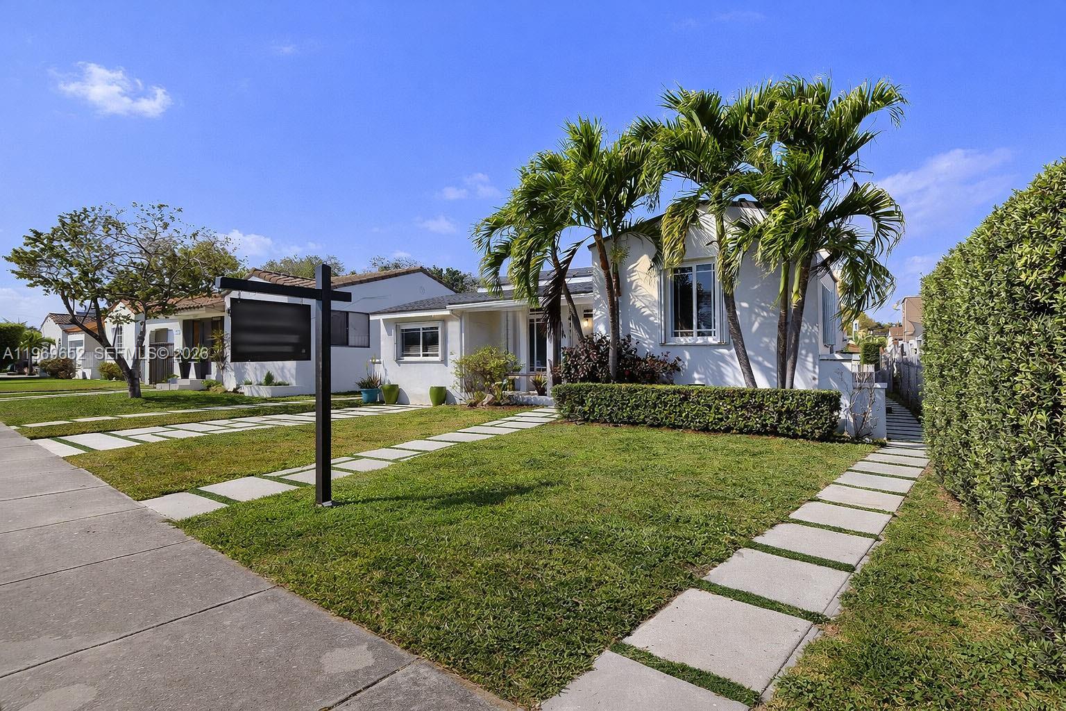 A white single-story house with palm trees and a paved walkway in the front yard — 1611 SW 21st St, Miami FL 33145, MIAMI, FL