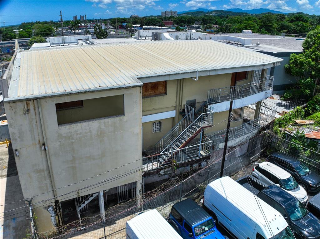An exterior view of a two-story building with a metal roof and an outdoor staircase — 662 DE DIEGO AVE SABANA LLANA WARD AVENUE, SAN JUAN, PR