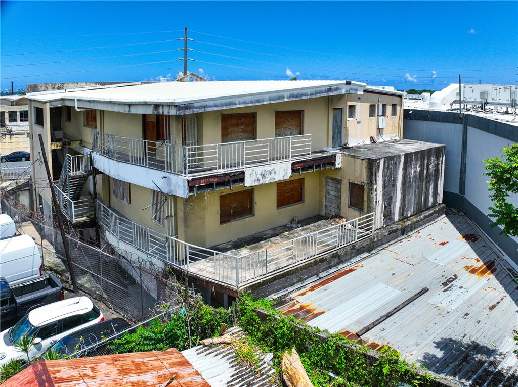 An exterior view of a weathered, multi-story building with boarded-up windows and metal balconies — 662 DE DIEGO AVE SABANA LLANA WARD AVENUE, SAN JUAN, PR