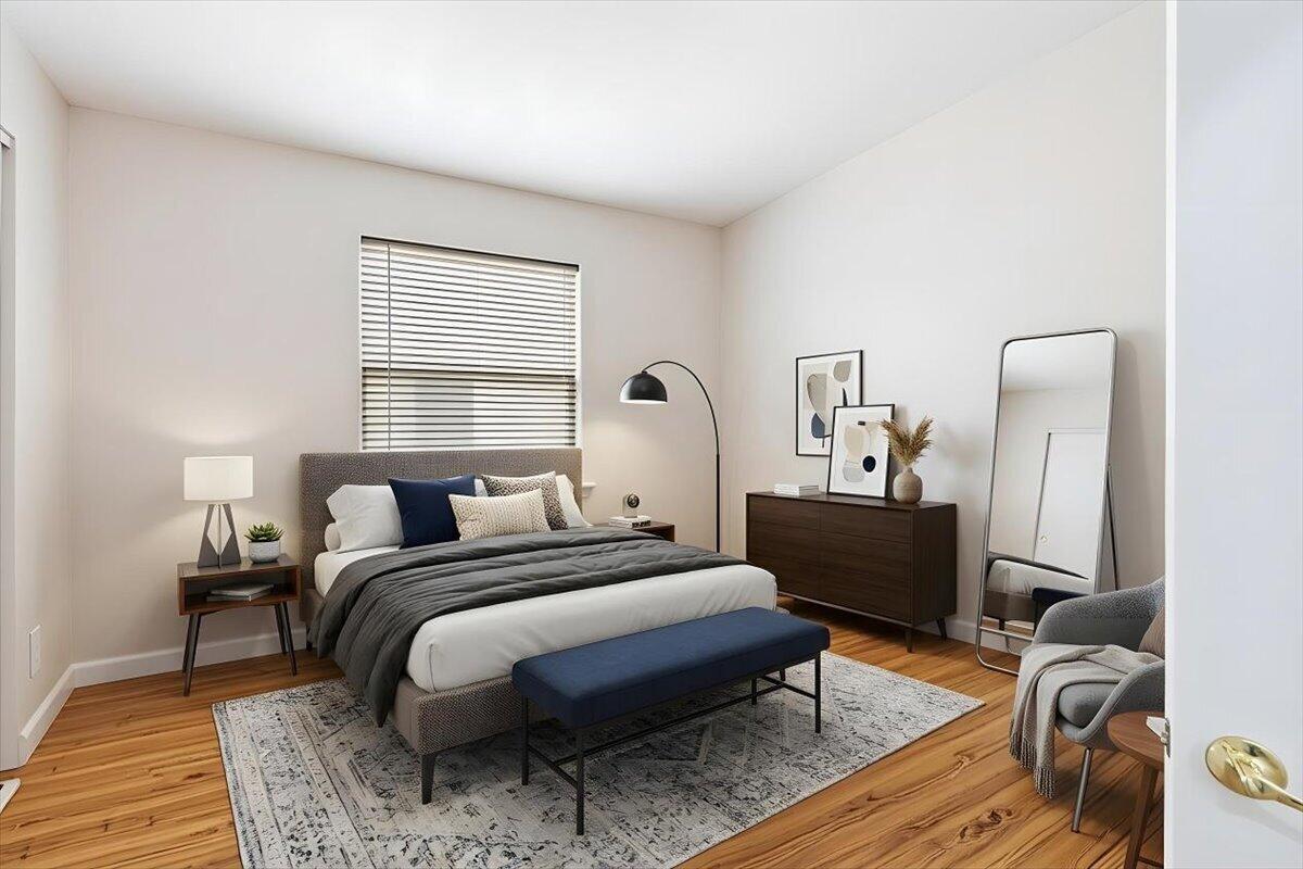 This bedroom features a bed with a blue bench, a dresser, and a floor mirror — 5185 Topaz Lane SW, Vero Beach FL 32968, VERO BEACH, FL