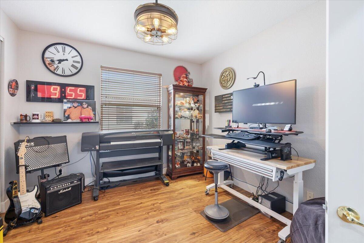 A home office features a standing desk, a large format printer, and a guitar setup — 5185 Topaz Lane SW, Vero Beach FL 32968, VERO BEACH, FL