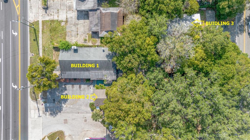 Aerial view of three buildings on a wooded lot adjacent to a multi-lane road — 2516 SANFORD AVENUE, SANFORD, FL