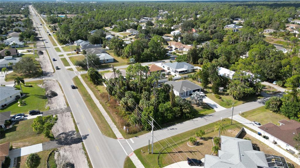 An aerial view shows a suburban neighborhood with houses, trees, and a paved road — 0 W PRICE BOULEVARD, NORTH PORT, FL