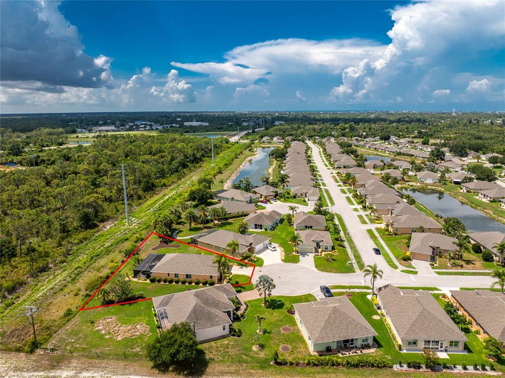 An aerial view shows a residential house outlined in red within a suburban neighborhood — 682 BARNACLE COURT, ENGLEWOOD, FL