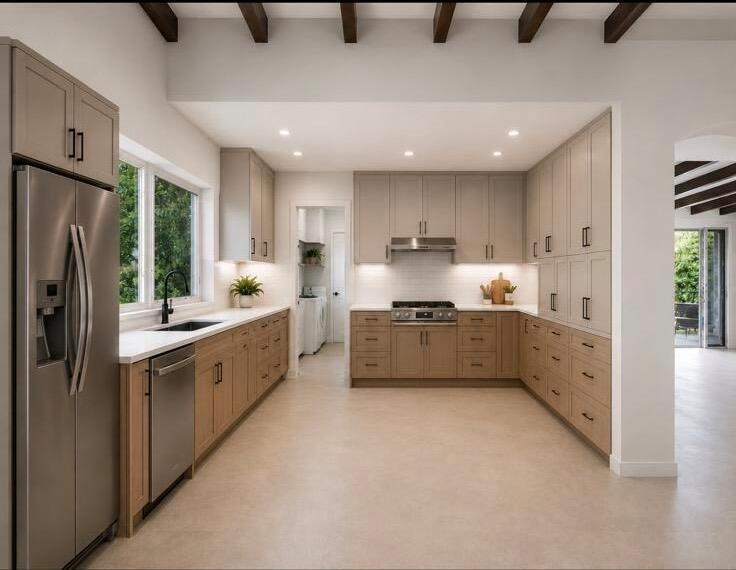 A modern kitchen features light wood cabinets, stainless steel appliances, and exposed ceiling beams — 2024 NE 26th Drive, Wilton Manors FL 33306, WILTON MANORS, FL