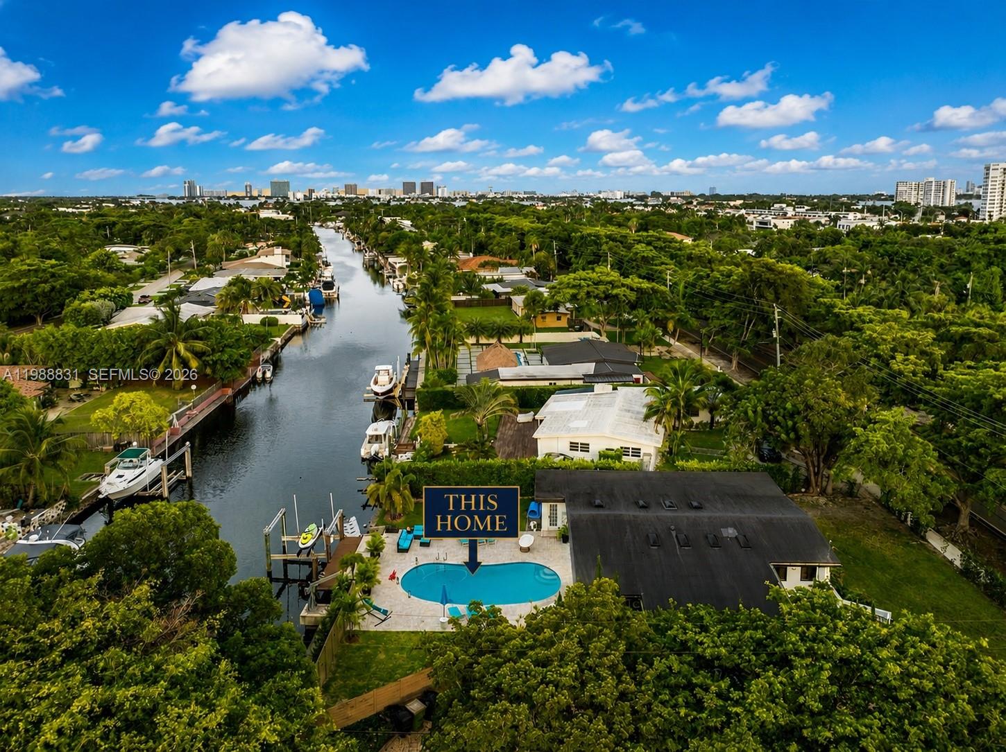 An aerial view shows a waterfront house with a swimming pool and a boat dock — 1805 Keystone Blvd, North Miami FL 33181, NORTH MIAMI, FL