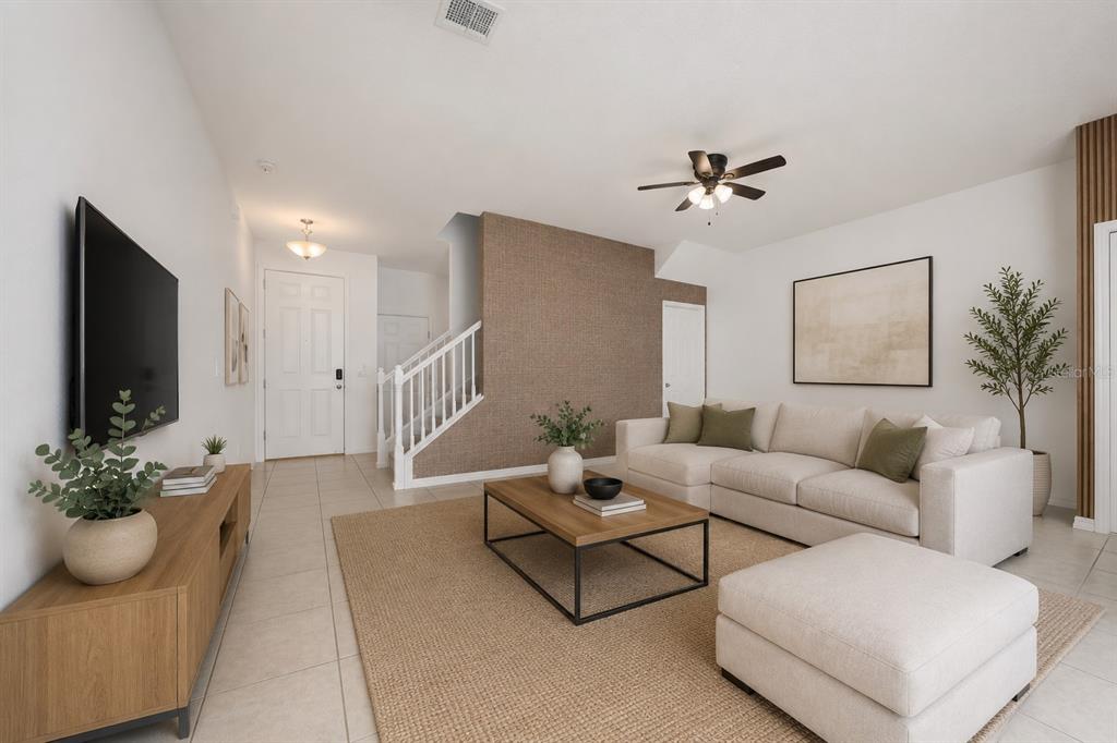 A living room features a beige sectional sofa, a wooden coffee table, and a textured wall — 2588 SEDGE GRASS WAY, ORLANDO, FL