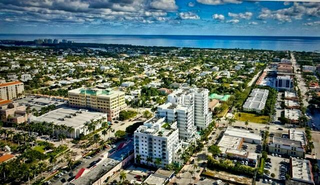 An aerial view shows a coastal city with multi-story buildings, residential streets, and the ocean — 155 E Boca Raton Road # 1110, Boca Raton FL 33432, BOCA RATON, FL