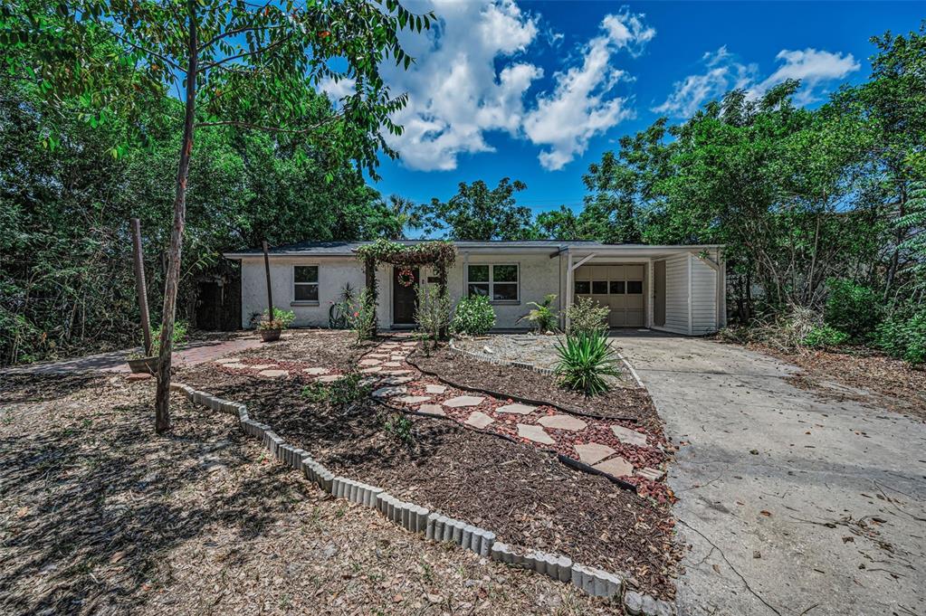 A single-story house with a stone walkway, a covered entryway, and an attached garage — 4312 BEACON SQUARE DRIVE, HOLIDAY, FL