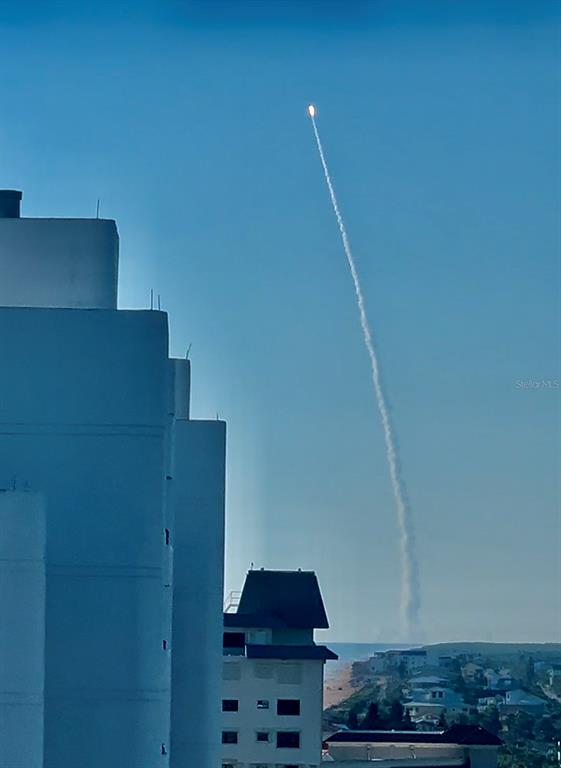 A view of a rocket launch in the sky above a coastal residential building — 5207 S ATLANTIC AVENUE UNIT 1226, NEW SMYRNA BEACH, FL
