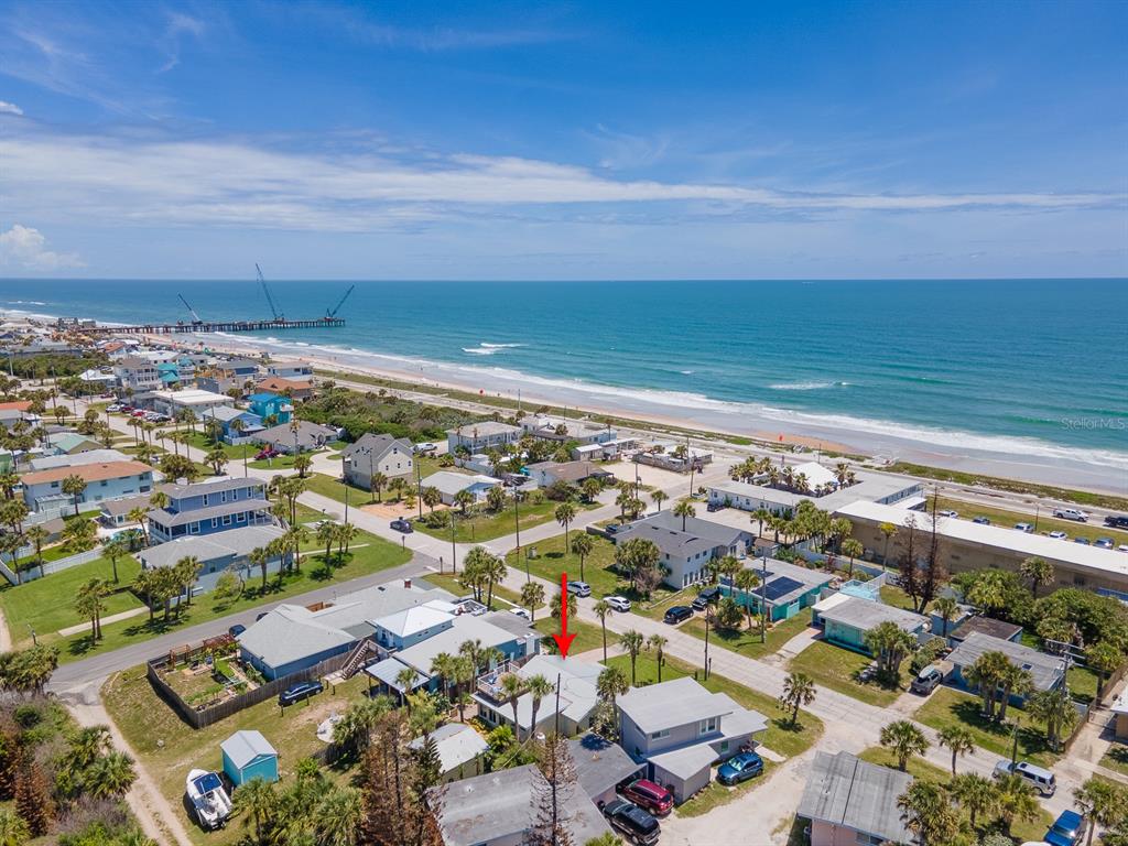 An aerial view shows a coastal neighborhood with houses near a beach and ocean — 1208 S CENTRAL AVENUE, FLAGLER BEACH, FL