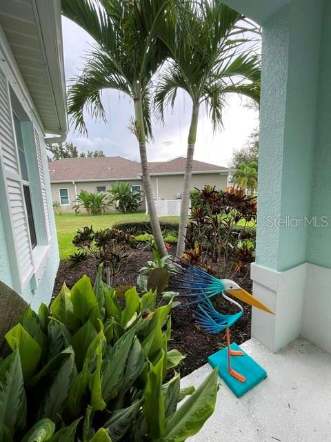 An aerial view shows three suburban houses with driveways and fenced backyards in a neighborhood — 4548 29TH AVENUE CIRCLE E, PALMETTO, FL