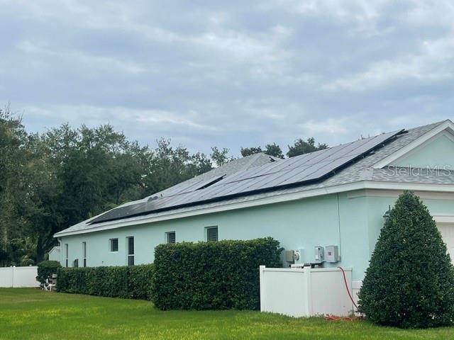 A metal bird sculpture stands on a porch overlooking a yard with palm trees — 4548 29TH AVENUE CIRCLE E, PALMETTO, FL