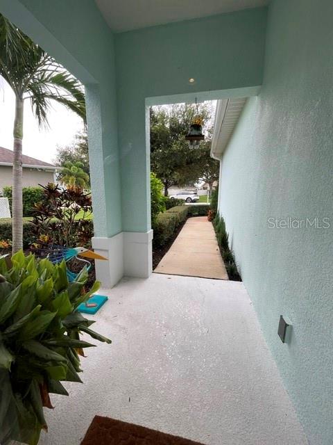 A backyard features a grassy lawn, a white vinyl fence, and a screened-in pool patio — 4548 29TH AVENUE CIRCLE E, PALMETTO, FL