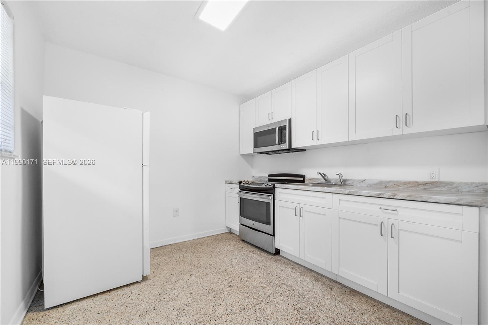 A kitchen features white cabinets, stainless steel appliances, and a light-colored countertop — 2661 SW 11th St # 8, Miami FL 33135, MIAMI, FL