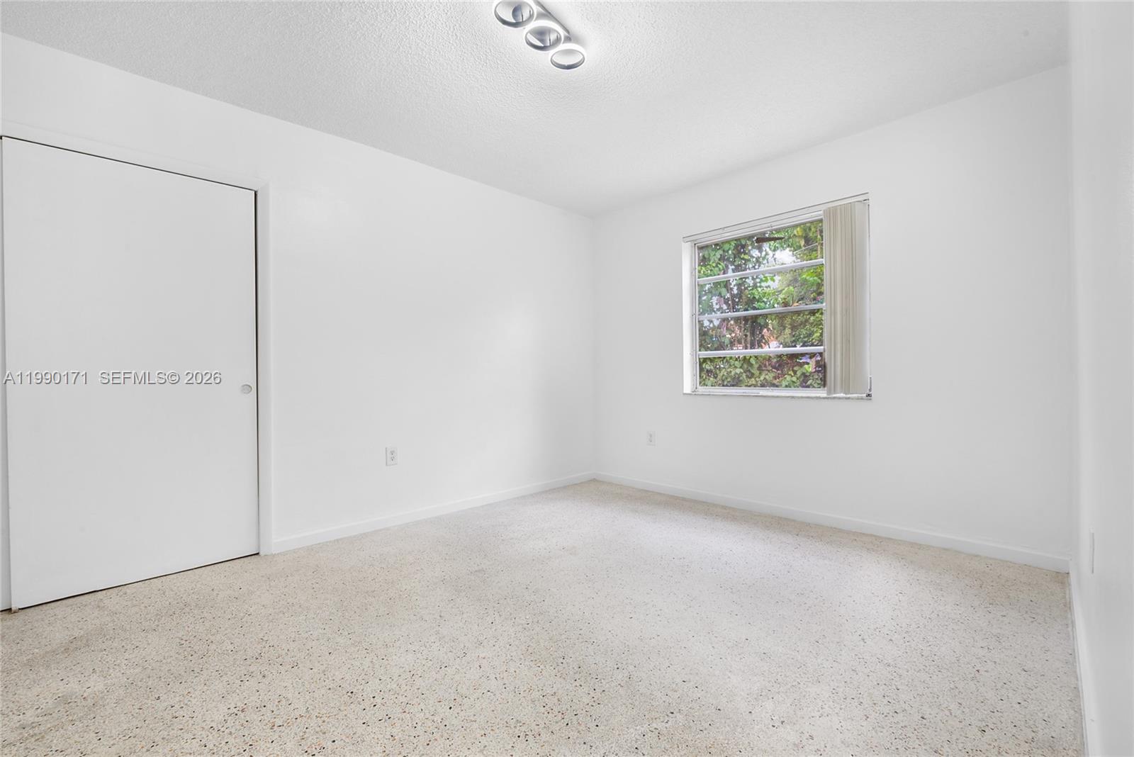 A bedroom features white walls, a closet with a white door, and a window — 2661 SW 11th St # 8, Miami FL 33135, MIAMI, FL