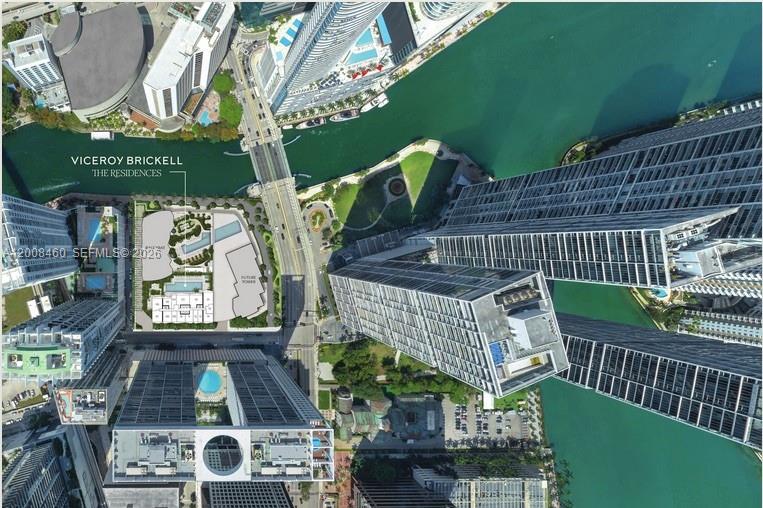 This aerial view shows a high-rise residential complex and surrounding urban buildings near a river — 77 SE 5th Street # 4014, Miami FL 33131, MIAMI, FL