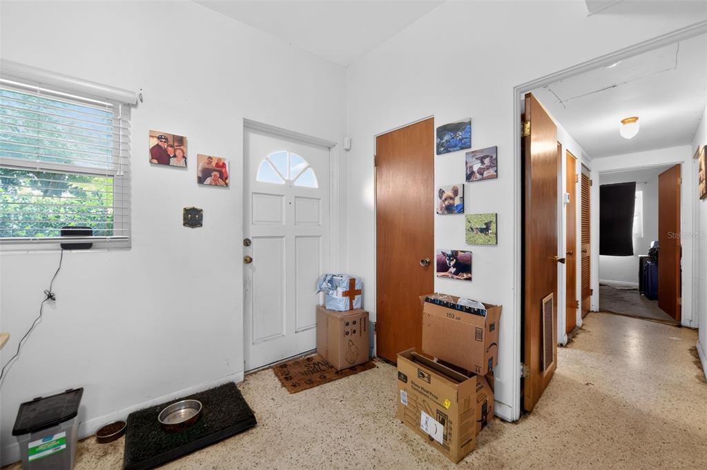 An entryway with a white front door, tiled floors, and several cardboard boxes — 2615 PEEL AVENUE, ORLANDO, FL