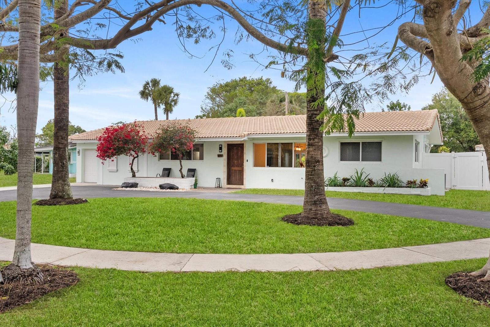 A single-story house with a light green exterior, tile roof, and a circular driveway — 1257 NW 5th Street, Boca Raton FL 33486, BOCA RATON, FL