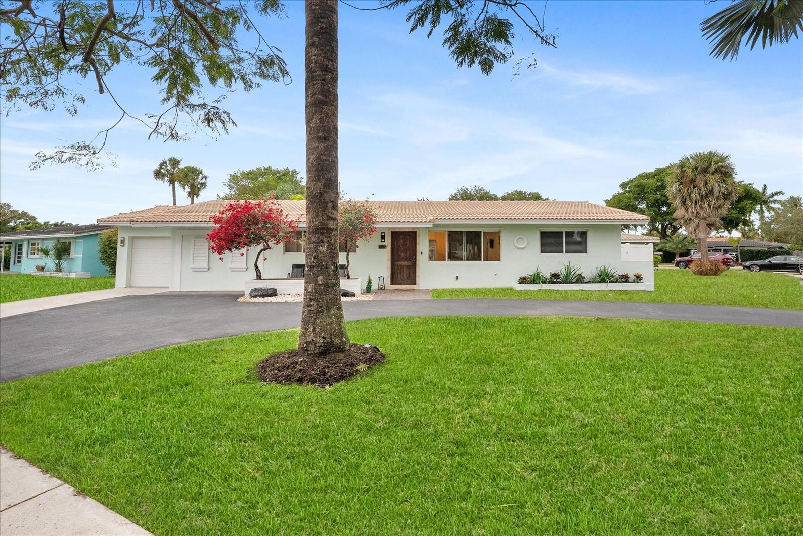 A single-story house with a light green exterior, a tiled roof, and a curved driveway — 1257 NW 5th Street, Boca Raton FL 33486, BOCA RATON, FL