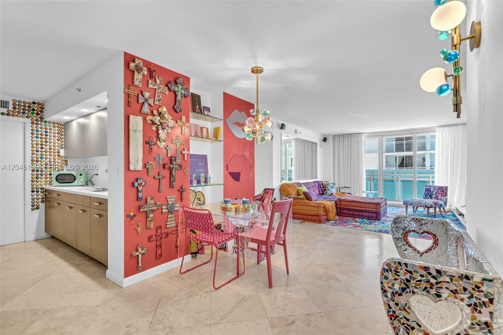 A living and dining area features a red wall decorated with numerous crosses and art — 6917 Collins Ave # 404, Miami Beach FL 33141, MIAMI BEACH, FL