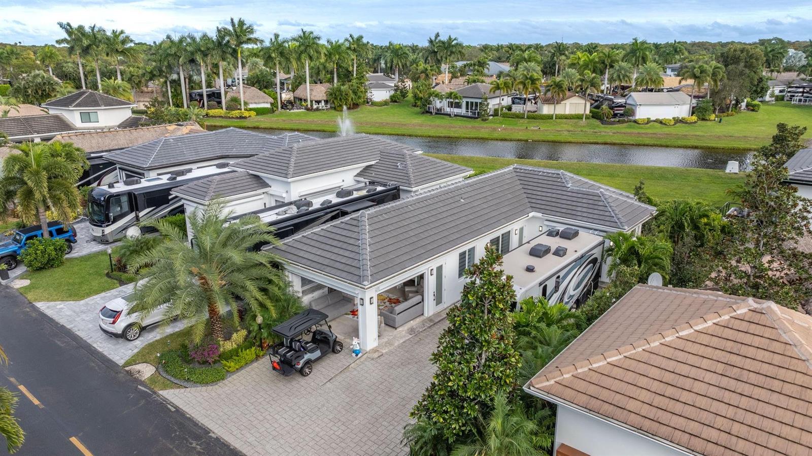 An aerial view shows a house with an attached RV garage, a golf cart, and landscaping — 633 N Cortez Drive # 633, Margate FL 33068, MARGATE, FL