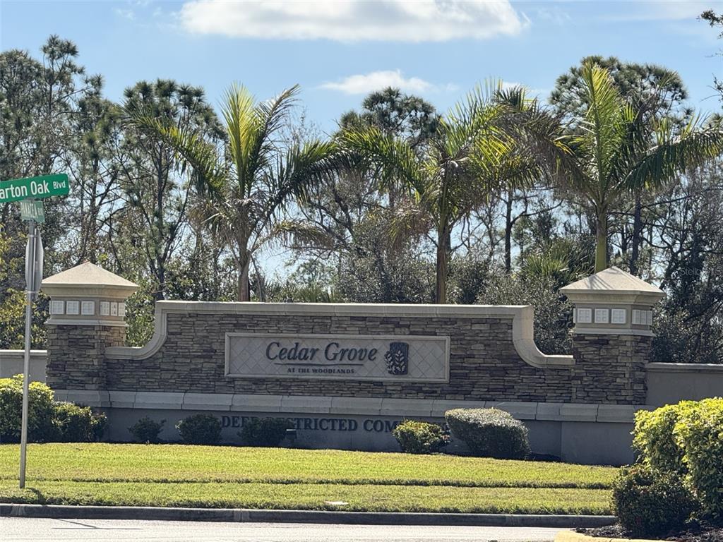 A stone monument sign for Cedar Grove at the Woodlands stands behind a grassy lawn — 2536 MARTON OAK BOULEVARD, NORTH PORT, FL
