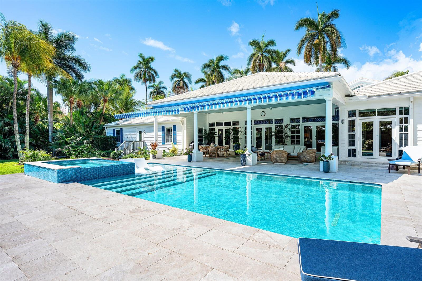 A backyard features a swimming pool with a spa, a covered patio, and palm trees — 1101 Thomas Street, Delray Beach FL 33483, DELRAY BEACH, FL