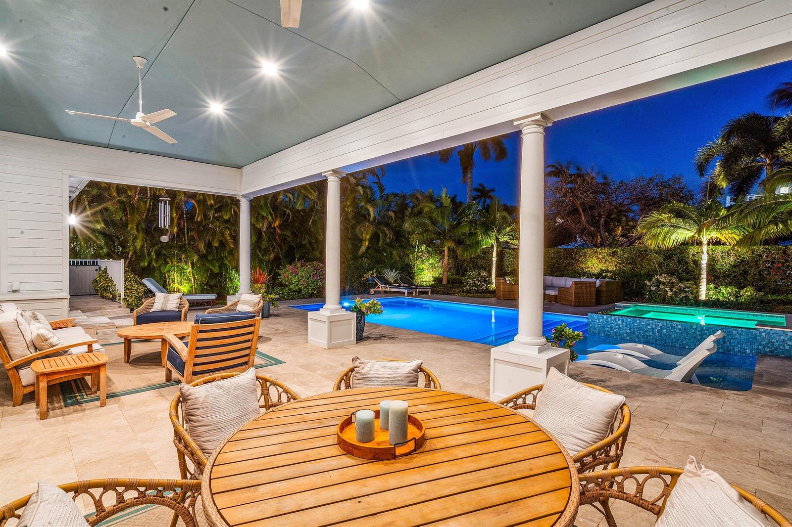 A covered patio features a dining set, lounge seating, a swimming pool, and a hot tub — 1101 Thomas Street, Delray Beach FL 33483, DELRAY BEACH, FL