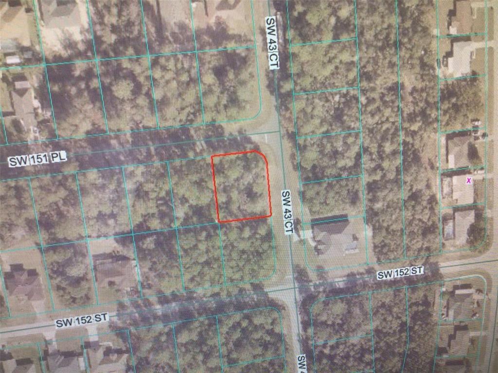This is a satellite map showing a vacant, wooded residential lot outlined in red — 0 SW 151 PLACE, OCALA, FL