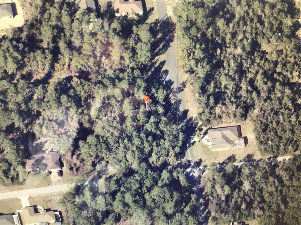 An aerial view shows a wooded residential lot marked with a red dot — 0 SW 151 PLACE, OCALA, FL