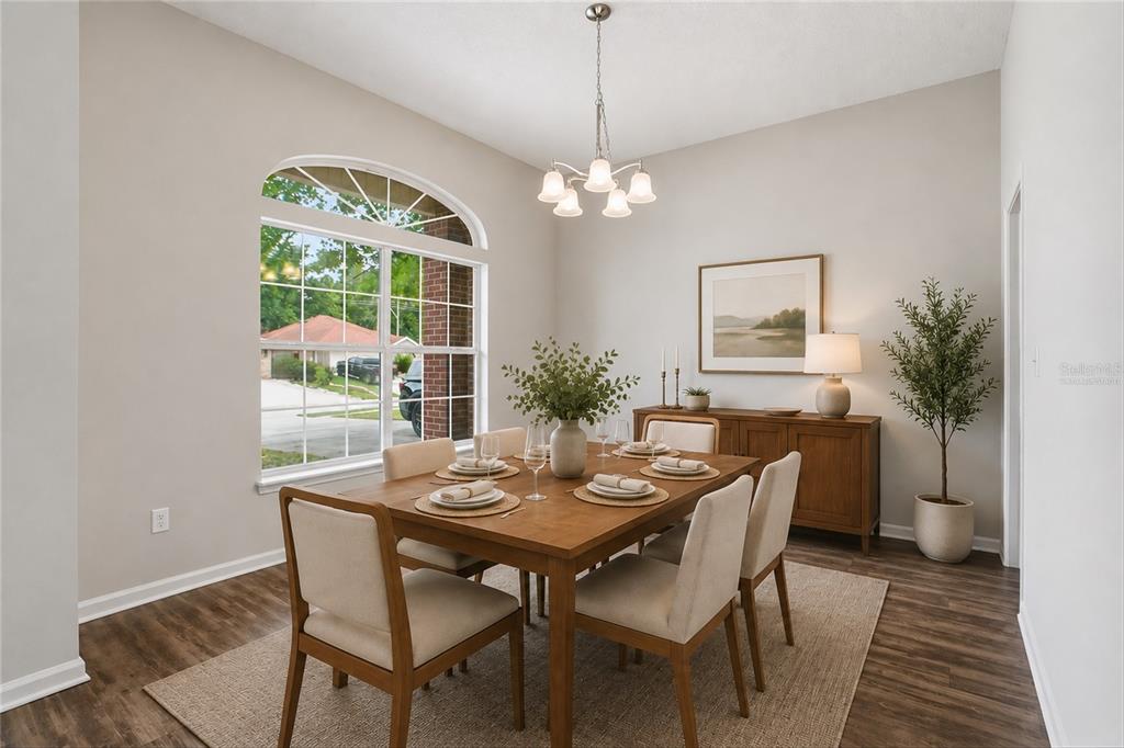 A bedroom features a bed, a dresser, a round mirror, and a ceiling fan — 5736 GUANA PARK COURT, JACKSONVILLE, FL