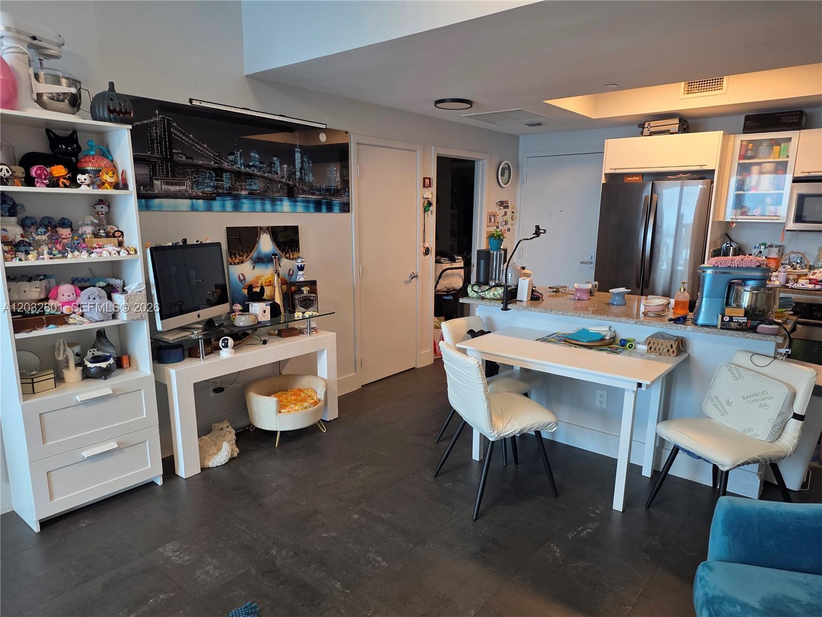 A kitchen and dining area features a white table, chairs, and a glass-topped desk — 888 Biscayne Blvd # 5107, Miami FL 33132, MIAMI, FL