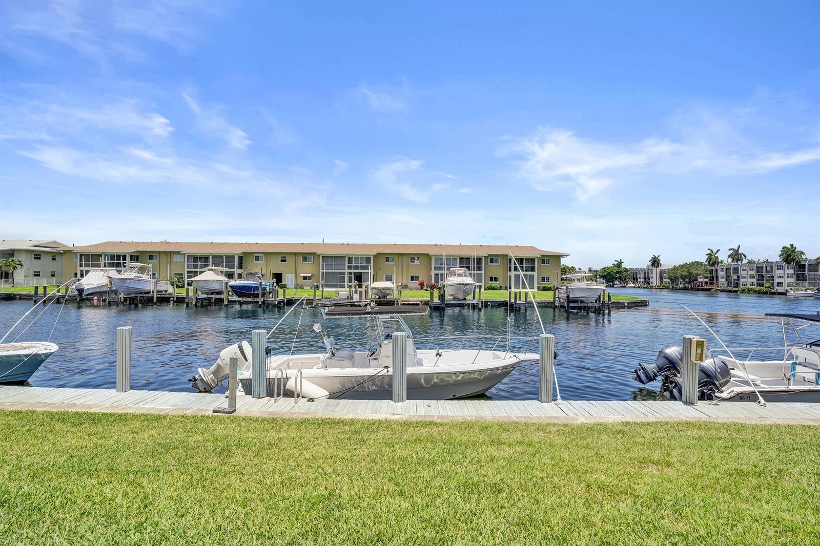 A view of a canal with several boats docked in front of a multi-story apartment building — 930 SE 9th Avenue # 11, Pompano Beach FL 33060, POMPANO BEACH, FL