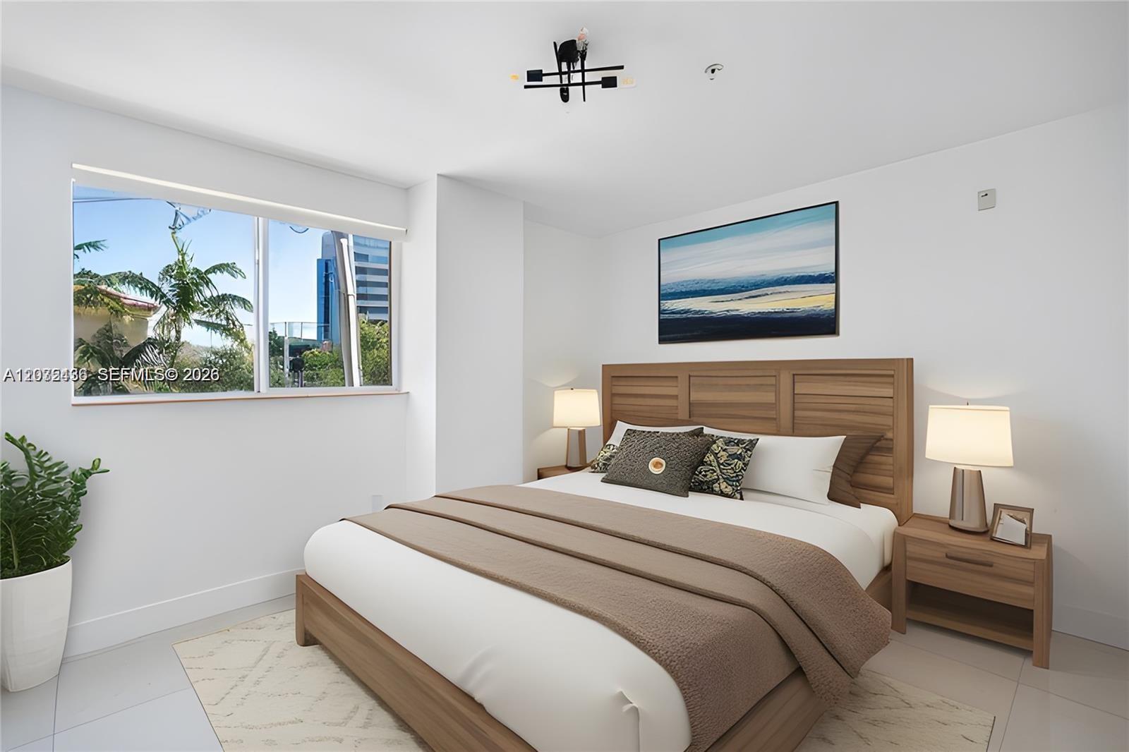 A bedroom features a wooden bed frame, two nightstands, and a window with city views — 2280 SW 32nd Ave # 201, Miami FL 33145, MIAMI, FL