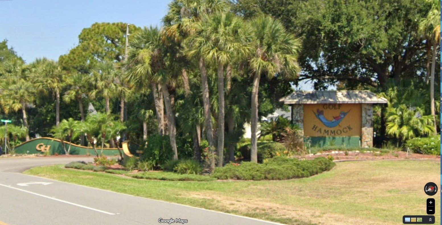The entrance to Golf Hammock features a large wooden sign and palm trees — 3401 Divot Road, Sebring FL 33872, SEBRING, FL