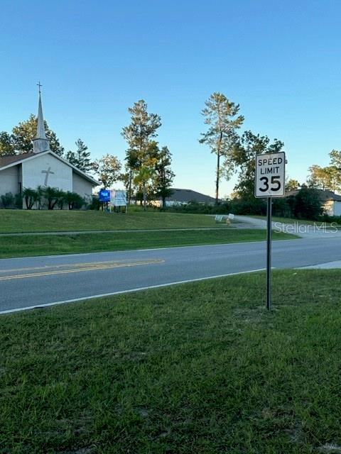 A church building stands near a road with a 35 mph speed limit sign — 1407 COURTLAND BOULEVARD, DELTONA, FL