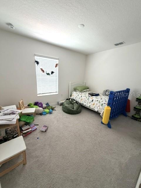 A bedroom features a twin bed, a beanbag chair, and a window with dinosaur decorations — 270 TARPON BAY BOULEVARD, HAINES CITY, FL