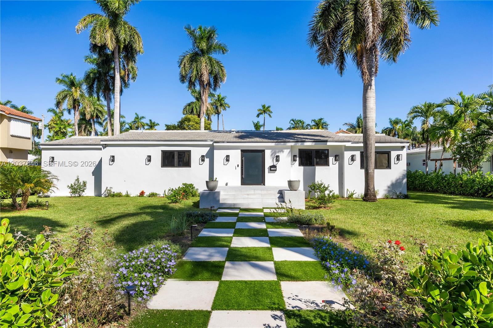 A white single-story house features a checkered walkway leading to a central front entrance — 1141 Hollywood Blvd, Hollywood FL 33019, HOLLYWOOD, FL