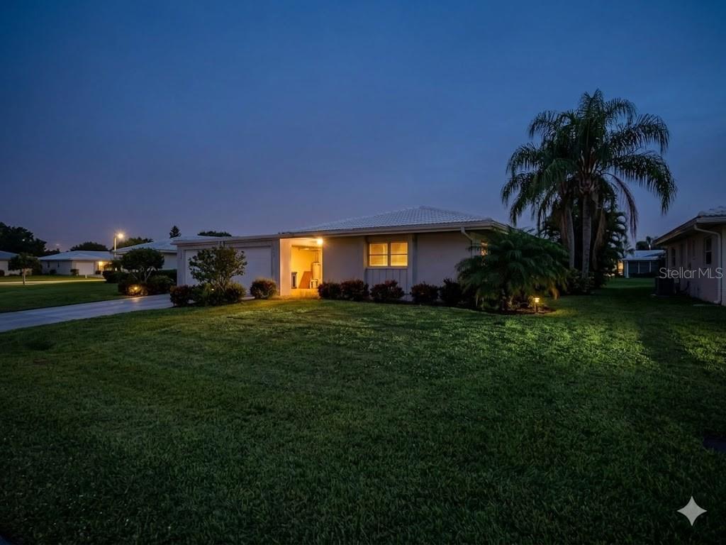 A single-story house with a light-colored exterior and a palm tree at twilight — 3280 SOUTHFIELD LANE UNIT 804, SARASOTA, FL