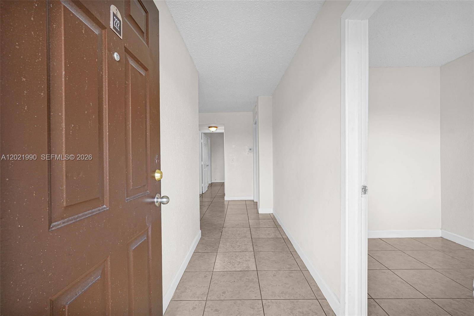 A brown door opens into a tiled hallway leading to an interior room — 400 NW 65th Ave # 222, Margate FL 33063, MARGATE, FL