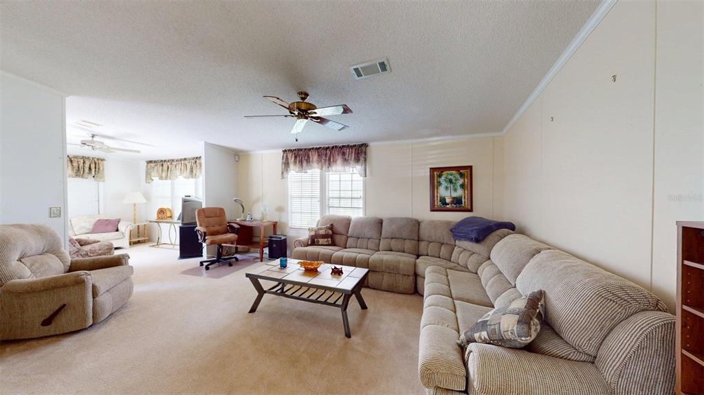 A living room features a large sectional sofa, a recliner, and a coffee table — 2100 KINGS HIGHWAY UNIT 534, PUNTA GORDA, FL